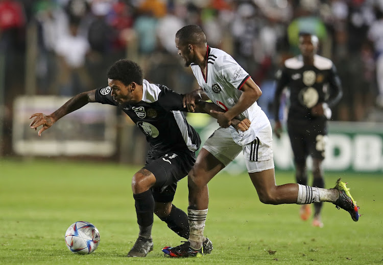 Justice Figareido of All Stars is challenged by Craig Martin of Orlando Pirates during their Nedbank Cup Last 32 match at the Wits Stadium.