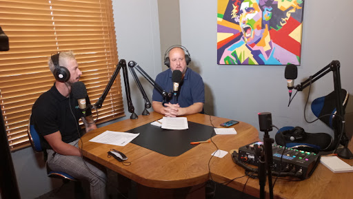 Bradley Bekker, head of brand at Evotel, and media personality Jon Gericke in studio during a podcast recording.