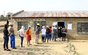 Locals stand in a queue to cast their votes during the parliamentary election at Tikwe Hatsolo, in the capital Maseru, Lesotho, October 7, 2022. 