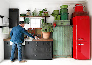 The kitchen's cabinetry comes in the form of loose units and mismatched, worn cabinets.