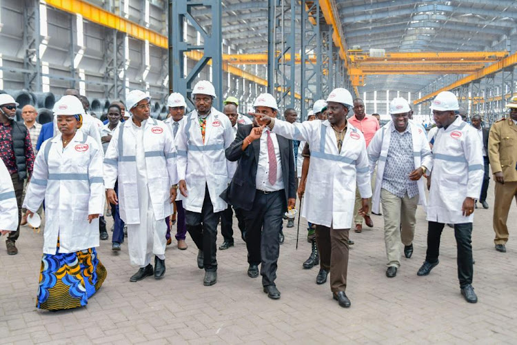 President William Ruto at the Devki Steel Mills in Kwale accompanied by First Lady Rachel Ruto, Public Service and Gender Cabinet Secretary Aisha Jumwa and Trade CS Moses Kuria among others on November 18.