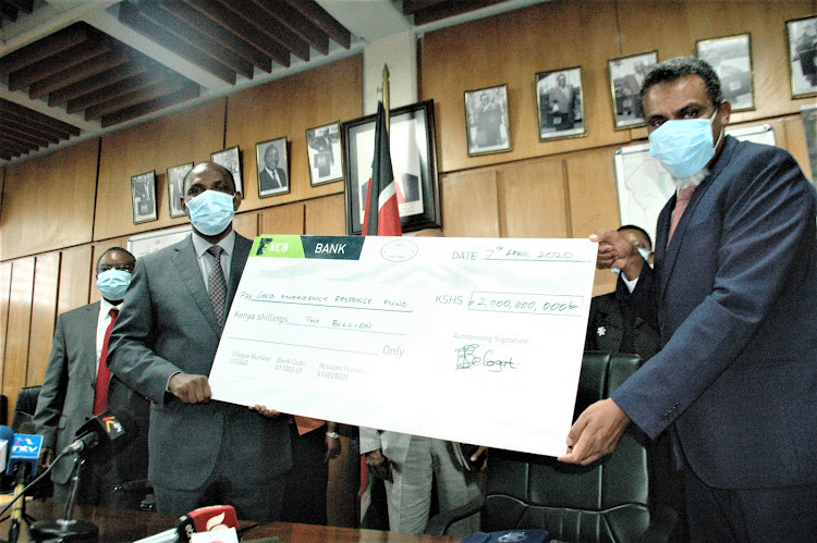 Treasury CS Ukur Yattani when he received a Sh2 billion Cheque from the Director of Public Prosecutions Noordin Haji.