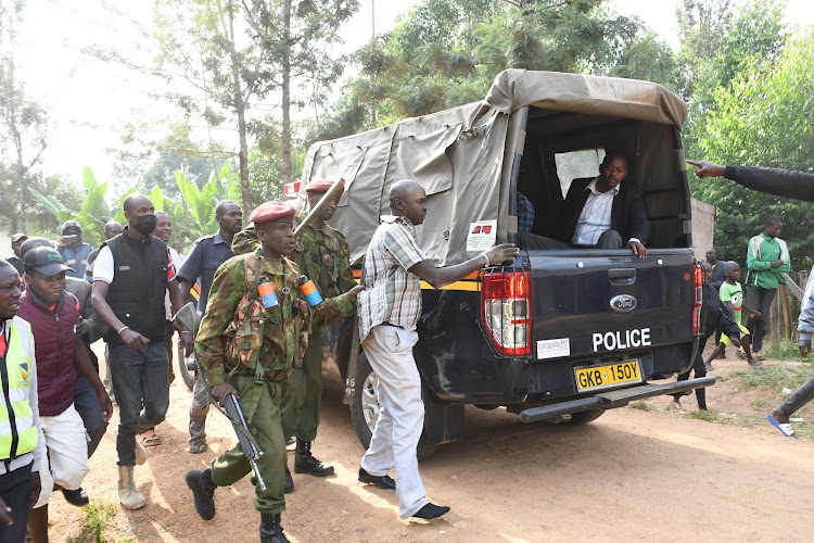 The driver of the vehicle that was used by the MPs bodyguards after being saved by the GSU. Inside the police landcruiser is one of Kaunya's bodyguards who was saved from a lynch mob.