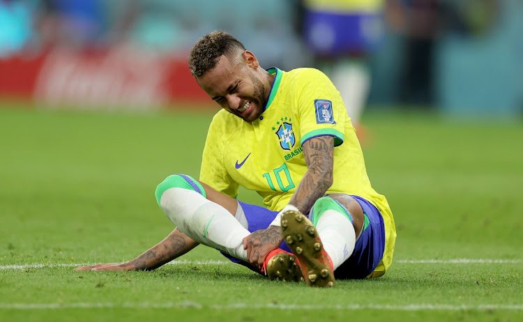 Brazil's Neymar sits injured on the pitch during the Fifa World Cup Qatar 2022 Group G match against Serbia at Qatar's Lusail Stadium on November 24 2022.