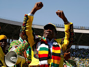 Zimbabwe's President Emmerson Mnangagwa greets supporters. 
