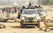 GUNS FOR AFRICA: Nigerian soldiers on patrol in Chibok as part of a major military operation to stem the wave of attacks by Boko Haram Islamic militants.