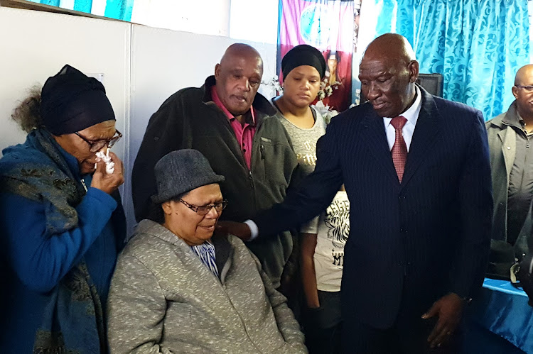 Police minister Bheki Cele comforts the mother of Sgt Donovan Prins, who was gunned down in Lavender Hill, Cape Town, on June 24 2019.