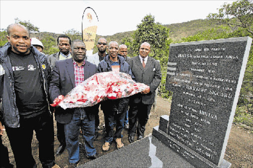 SOLEMN MOMENT: MAY 08, 2017: Ngcangathelo Chief Phathuxolo Tyhali, Mbhashe Mayor Samnkelo Janda, and Xhosa King Mpendulo Zwelonke Sigcawu during the laying of wreaths at the grave of legendary Xhosa monarch King Hintsa, on the banks of Nqabarha River near Willowvale last week Picture: LULAMILE FEINI