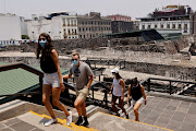 Tourists are seen at the archeological site Templo Mayor as it re-opens after almost a year of closures due to the coronavirus disease (Covid-19) pandemic, in Mexico City, Mexico April 28, 2021.