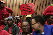 Members of the South African Communist Party (SACP) hold up a placard before parole application of Chris Hani's killer, Janusz Walus, 7 August 2018, at the North Gauteng High court in Pretoria. 