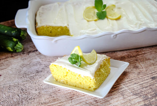 A slice of Lemon Zucchini Cake With Lemon Cream Cheese Frosting.