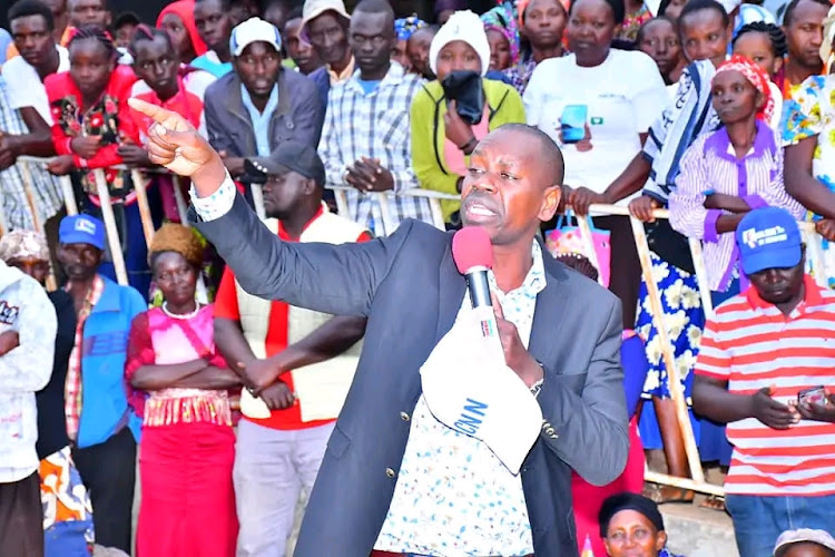 Mwingi West MP Charles Nguna addressing residents during his campaign tour at Nzaaiku market in Mwingi West on Sunday, July 10.