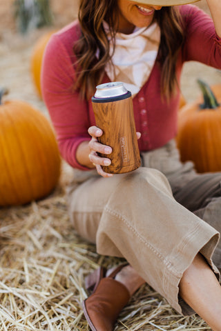 woman holding drink tumbler.