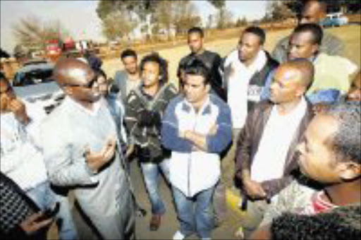 MIDDLEMAN: Deputy minister of Home Affairs Malusi Gigaba meets with a group of foreigners who were attacked by residents of Siyathemba in Mpumalanga during the recent service delivery protest. PIC. VELI NHLAPO. 28/07/2009. © SOWETAN