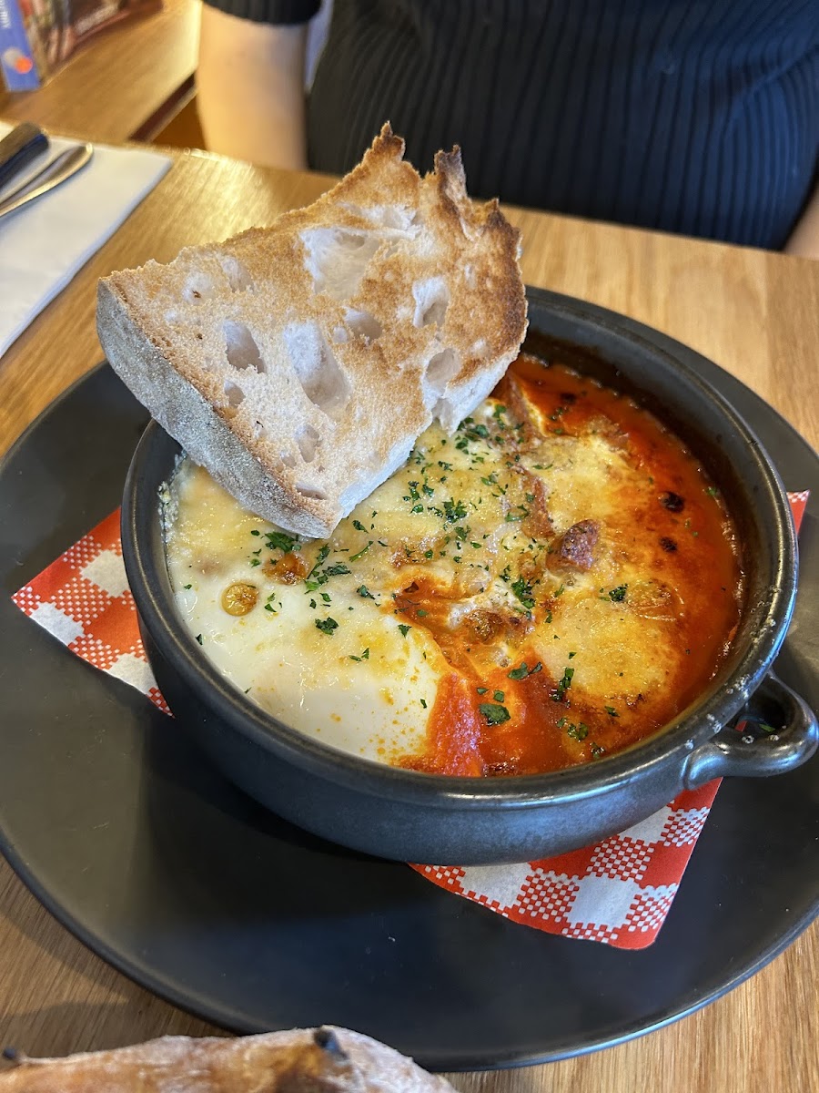 Eggs in the Forno (baked eggs, pork sausage, cannellini beans, parmesan, sugo & gluten free bread)