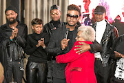 Fashion designer David Tlale hugs his mother, Joyce.