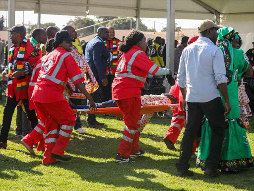 Medics attend to people injured in an explosion during a rally by Zimbabwean President Emmerson Mnangagwa in Bulawayo, Zimbabwe June 23, 2018. /REUTERS