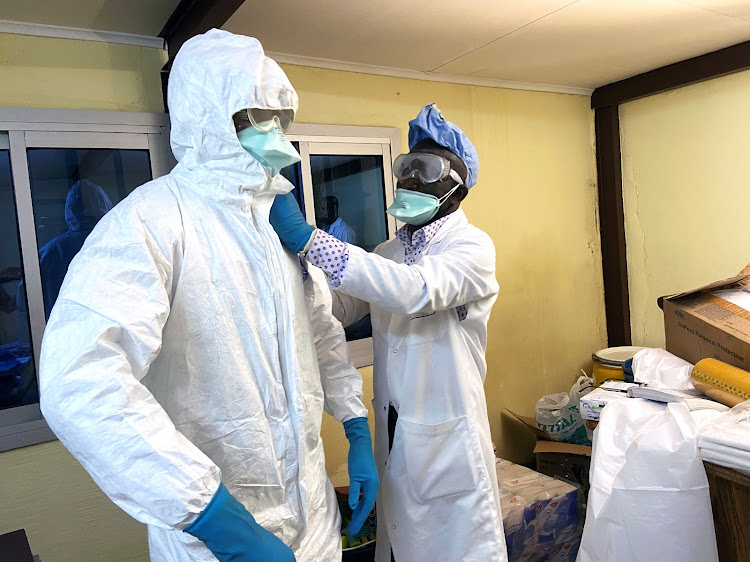 A medical staff wears protective gear at a new section specialised in receiving any person who may have been infected with coronavirus at The Quinquinie Hospital in Douala, Cameroon February 17, 2020. Picture taken February 17, 2020. REUTERS/Josiane Kouagheu