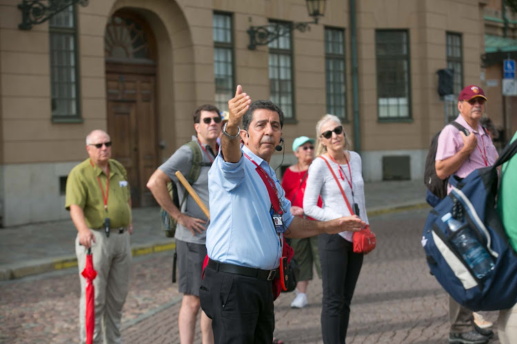 A  guide for Viking Ocean Cruises leads a tour group in Stockholm.