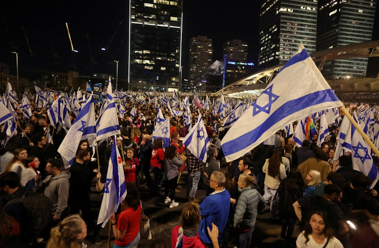 People attend a demonstration after Israeli Prime Minister Benjamin Netanyahu dismissed the defense minister and his nationalist coalition government presses on with its judicial overhaul, in Tel Aviv, Israel, March 26 2023. Picture: NIR ELIAS/REUTERS