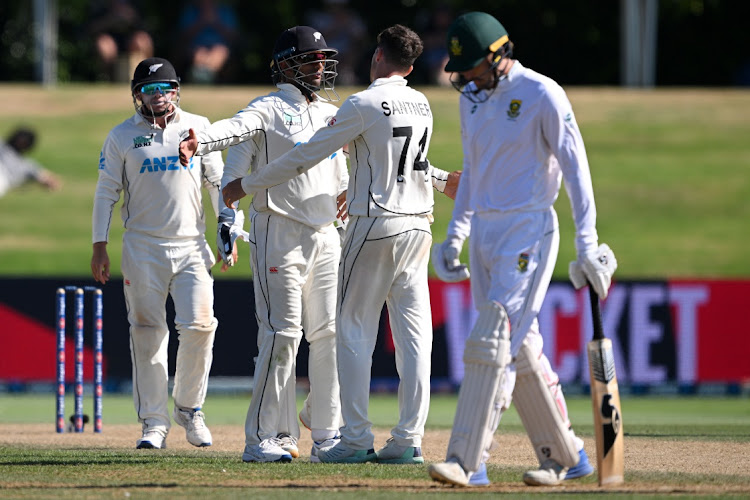 Ruan de Swart sums up the Proteas' disappointment while Mitchell Santner and his new Zealand teammates celebrate another wicket on the final day of the first Test at Bay Oval in Mt Maunganui on Wednesday.