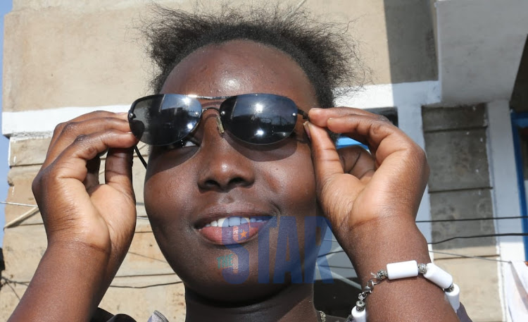 Bernice Lisa watches the solar eclipse happening across the world on 21 June 2020.