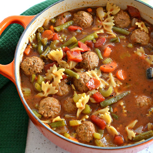 This family friendly tasty Meatball Soup is a cinch to make using frozen or fresh meatballs and a handful of fresh cut vegetables.  It is lightly seasoned with Italian spices in a tasty beefy tomato broth.  