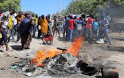 Protesters burn campaign pictures of Somalia's President Mohamed Abdullahi Mohamed on the streets of Yaqshid district of Mogadishu, Somalia April 25, 2021. 