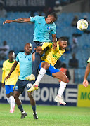 Moses Mthembu of Richards Bay jumps the highest as he fights for ball possession against Mamelodi Sundowns players on Tuesday night. 