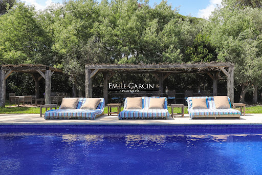 Pool with lounge chairs and wooded pergolas in this luxury villa for seasonal rental in Saint-Tropez ($38,868)