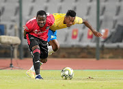 Lebohang Maboe of Mamelodi Sundowns tussles for possession with    Bucs' Gabadinho  Mhango  during their  match on Tuesday. 