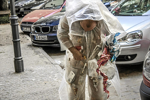 A still from the video performance of Kai Lossgott in his 'Hunter-gatherer' suit, collecting urban detritus for future categorisation.