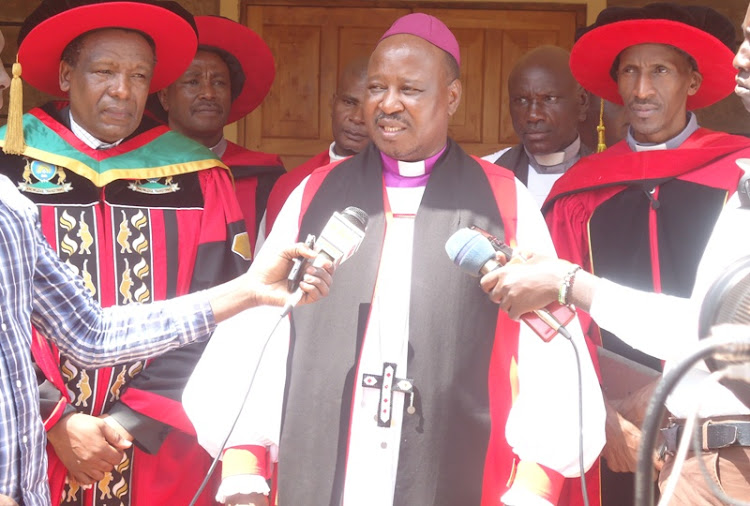 Mbeere ACK Diocese's Bishop Moses Masamba flanked by University of Embu Vice-Chancellor Daniel Mugendi speaks to the press at Kanyuambora ACK Church on June 8.