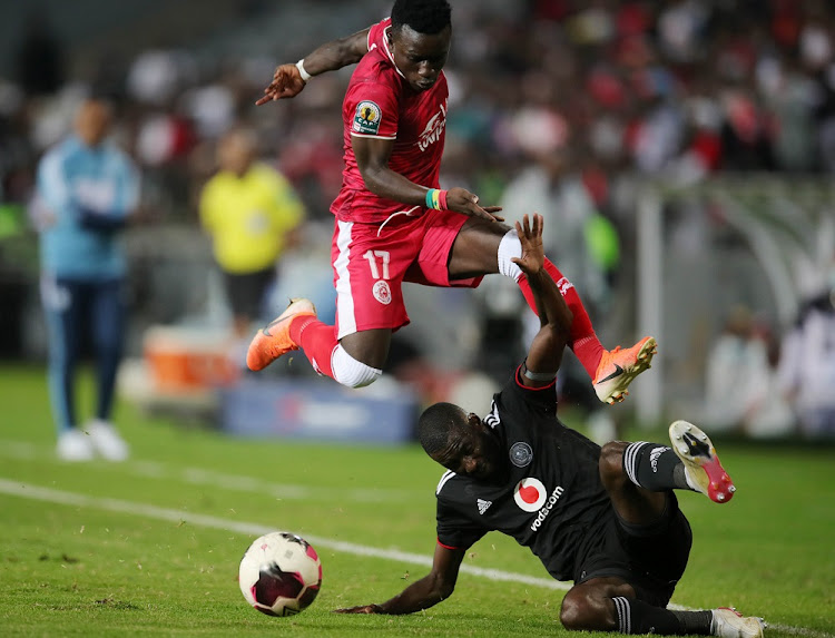 Pape Sakho of Simba SC is tackled by Deon Hotto of Orlando Pirates in the Caf Confederation Cup quarterfinal second leg match at Orlando Stadium on April 24.