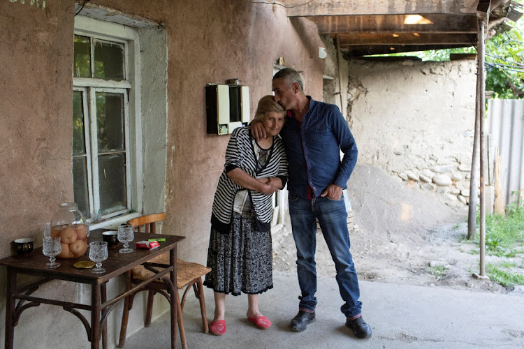 Ramaz Begheluri, 35, who says he has been kidnapped several times by Russian-backed separatists, and his mother Nona Behgeluri, 53, pose for a picture at their home, near the border of Georgia's breakaway region of South Ossetia, in the village of Gugutiantkari, Georgia. File photo: REUTERS/DARO SULAKAURI