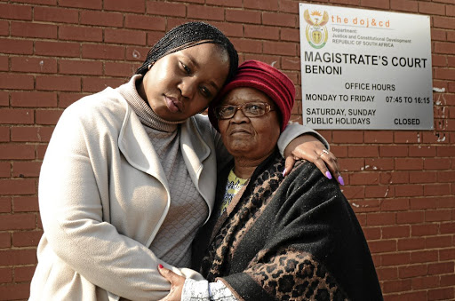 Nomava Dire, the daughter of the late Senkubele Dire, with her aunt Gabantathe Dire, outside the Benoni Magistrate's Court yesterday where they were attending a case of two suspects found with the late doctor's car.