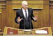 Greek Prime Minister George Papandreou delivers a speech during a debate before a vote of confidence in parliament in Athens on friday.