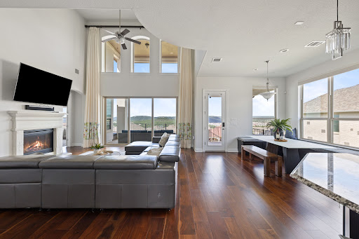 Spacious living room with fireplace and view in this luxury house for sale in Leander ($990,000)