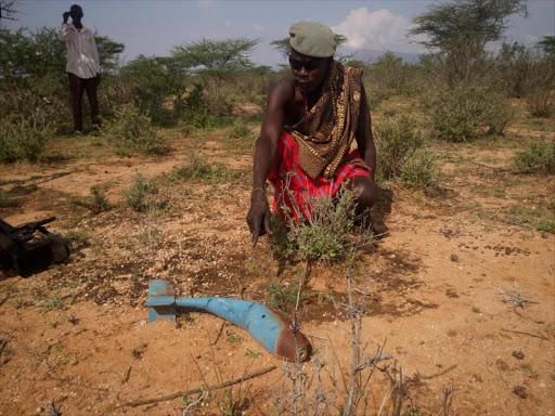 Stephen Elegae, a resident, shows a live rocket grenade./MARTIN FUNDI