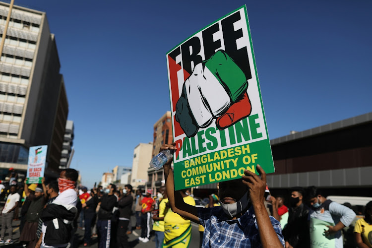 A demonstrator holds a placard during a Palestine solidarity march in Buffalo City, May 23 2021. Picture: ALAN EASON