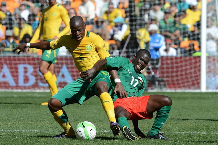 Hlompho Kekana of Bafana Bafana and Barro Sidiki during the International Friendly match between South Africa and Burkina Faso at FNB Stadium on August 17, 2013 in Soweto, South Africa. (Photo by Lefty Shivambu/Gallo Images)