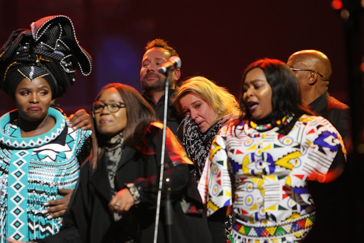 South African vocalist and Musician Karen Zoid (Centre) cries as acollection of South African Artists sing the popular song “The Crossing” .