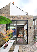 While most of the garden is laid to brick, a corridor of pink and terracotta tiles - a nod to the owner's love of Barcelona - leads to the side extension.