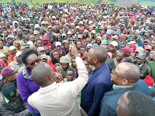 Ololulung’a MCA Jafferson Langat (left) with Melelo MCA Philemon Aruasa (centre) and Bomet Central MP Ronald Tonui speak to the Mau evictees at Kitoben area of Narok South Sub County on Saturday.