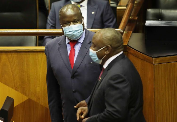 Finance minister Tito Mboweni talks to President Cyril Ramaphosa ahead of his 2021 budget speech at parliament in Cape Town, on February 24 2021.