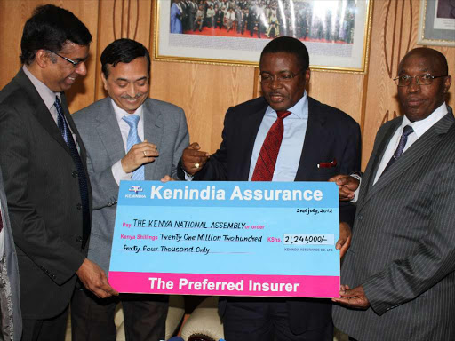 Kenindia Insurance Managing Director Madipatla Sarma (2nD L) with General Manager Makuni Jairam present a cheque to the speaker Kenneth Marende and Clerk of the National Assembly Patrick Gichohi group accident cover of Ksh 21, 244,000 of the Late Internal Security Min Prof George Saitoti and his assistant Minister Orwa Ojode in Parliament Yest. Photo/ Jack Owuor