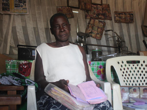 Traditional birth attendant Petty Akoth shows documents of children who have been delivered at her home ‘clinic’ in Sofia estate, Homa Bay town, on May 7. / ROBERT OMOLLO