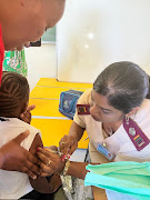 A child receives a vaccination as part of a national campaign against measles.