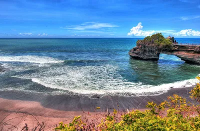 Tanah Lot, a rock formation off the Indonesian island of Bali. It is home to the pilgrimage temple Pura Tanah Lot, a popular cultural icon and photography magnet.