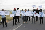 INDUSTRIAL ACTION: Nothemba Funeral Services workers picket outside the 
      
       company's offices in Khayelitsha. 
      
      
      
      PHOTO:  LUTHO QWAMBI